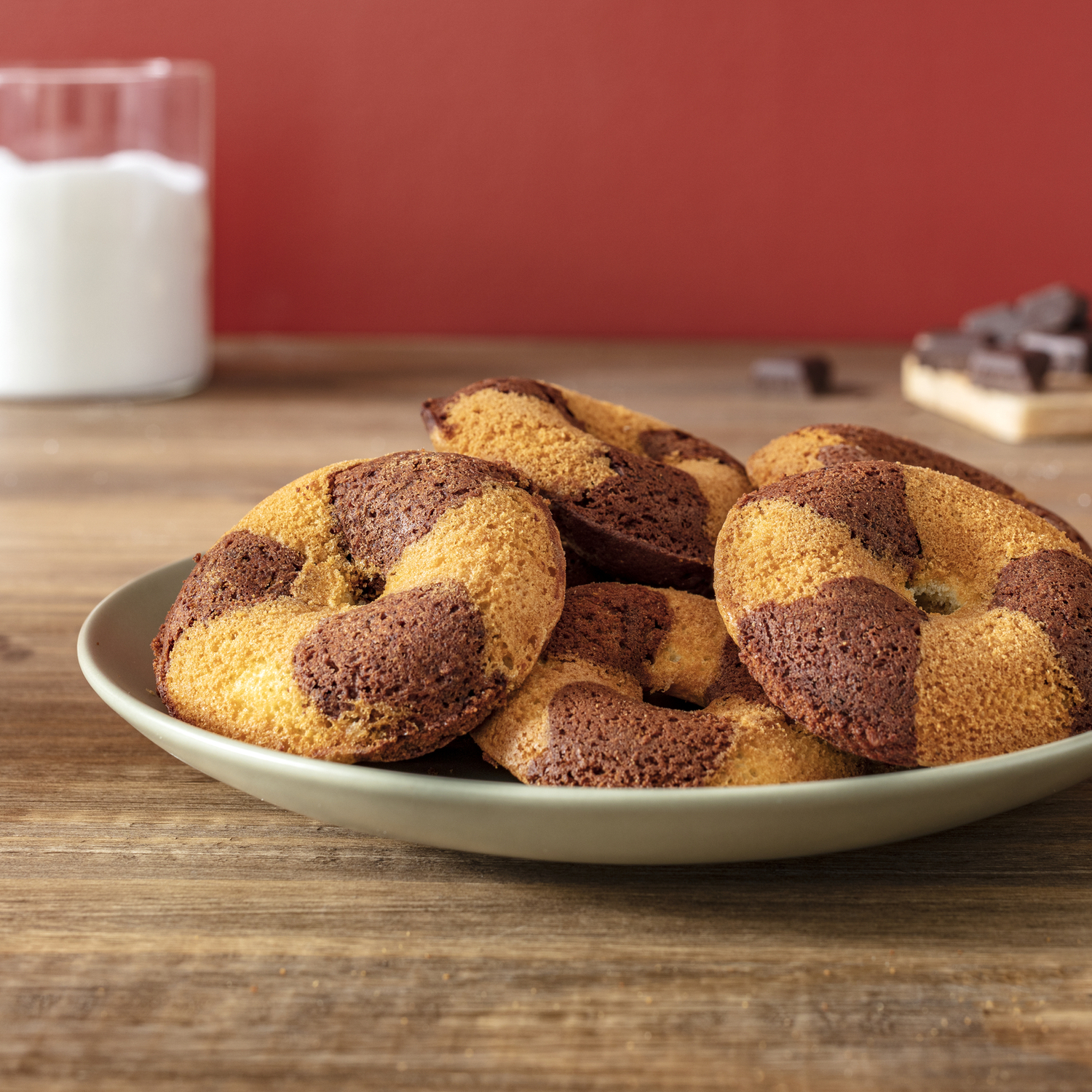 Plate of cookies, half chocolate, on a wooden table.