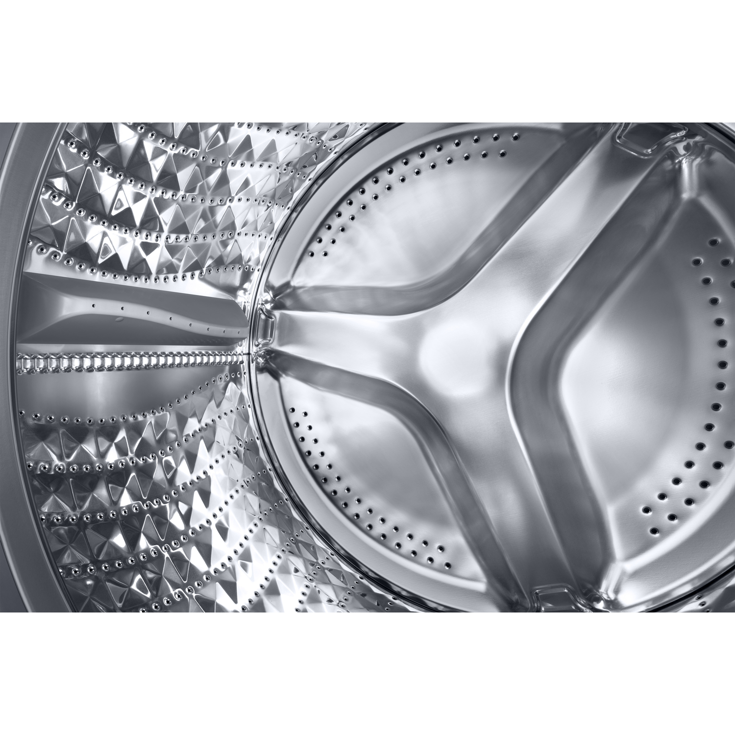 Inside of a washing machine drum, showing the stainless steel interior with diamond-shaped patterns and holes.