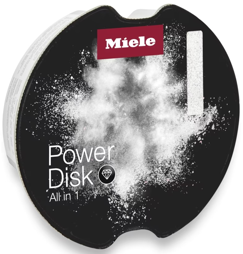 Tabletka do zmywarki Miele Power Disk All in 1. Czarny dysk z białym proszkiem.