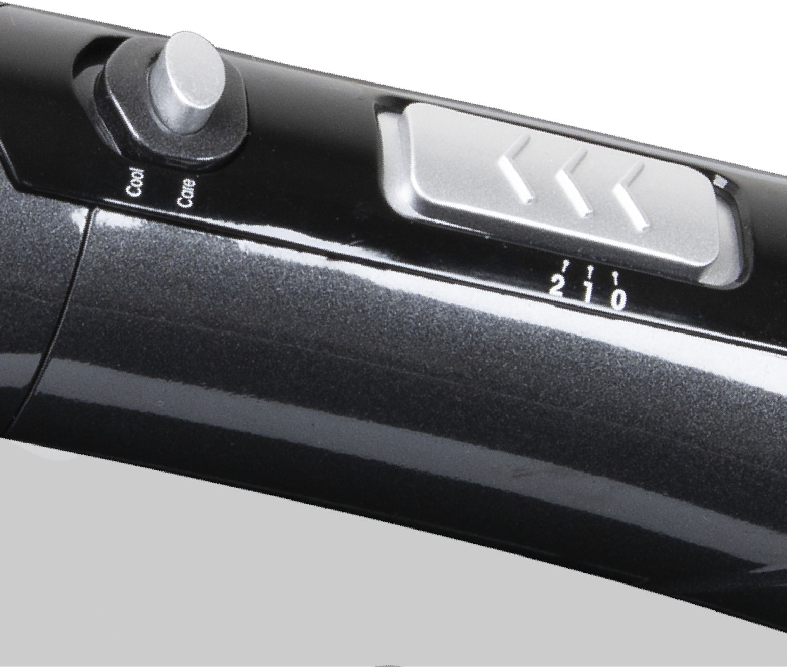 Close-up of a hair dryer with settings. Cool, Care settings and numbered buttons.