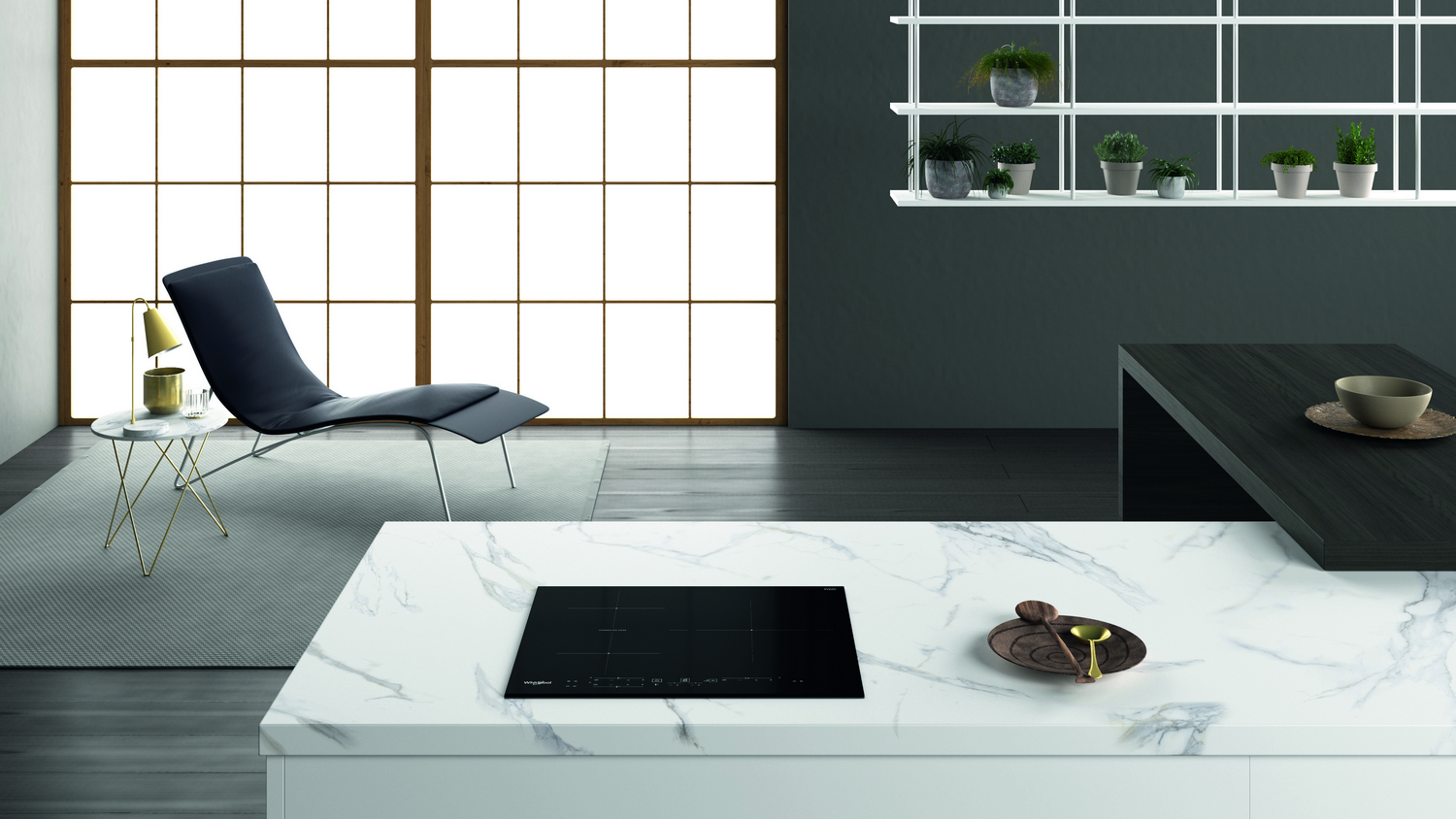 Cocina moderna con vitrocerámica negra sobre encimera blanca. Silla y ventana en el fondo.