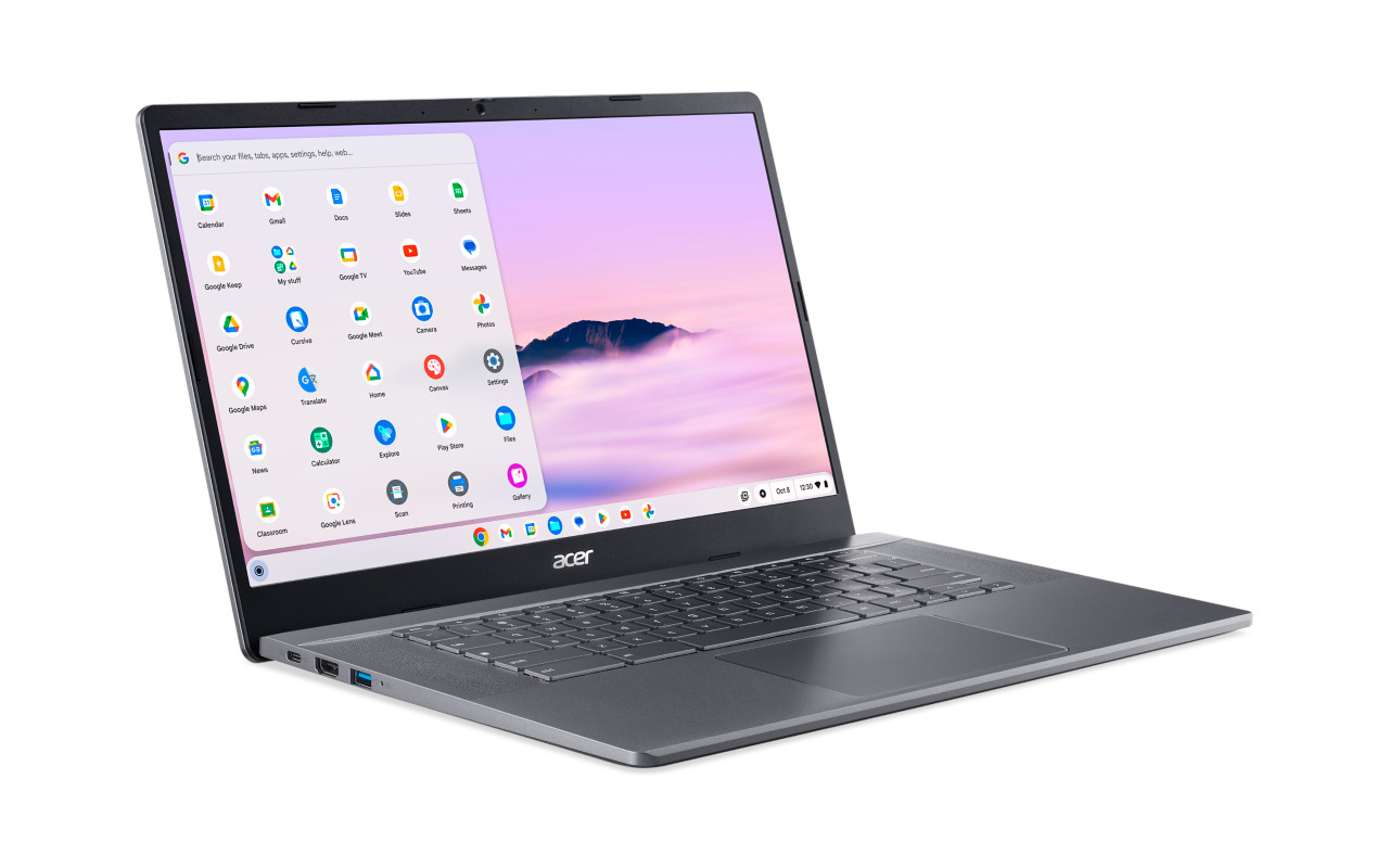 Gray laptop with open screen, showing apps, on a white surface.