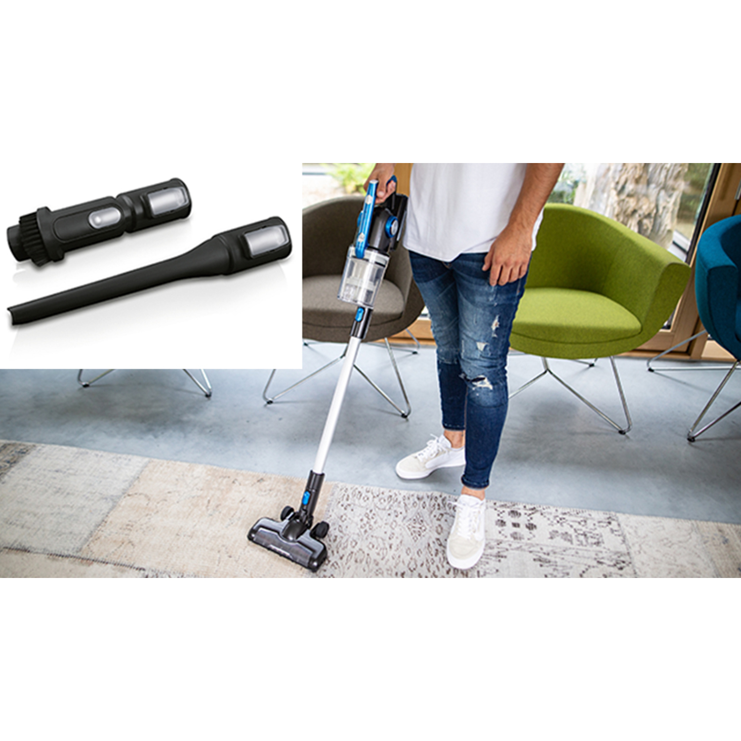 A person in jeans and a white shirt using a vacuum cleaner. Two parts of the vacuum are nearby.