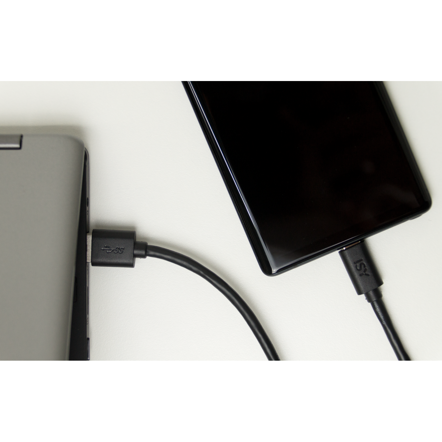 A laptop and a smartphone connected by a USB-C cable for charging.