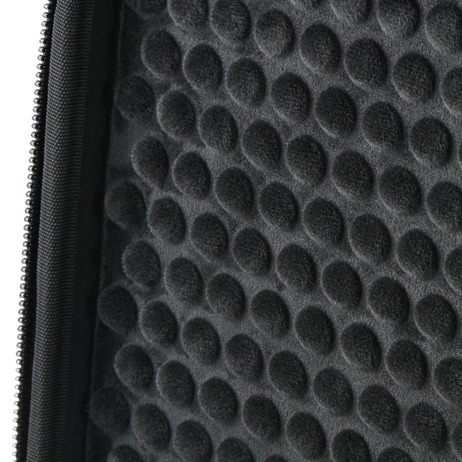 Close-up of a black protective case interior with a textured, bumpy surface.