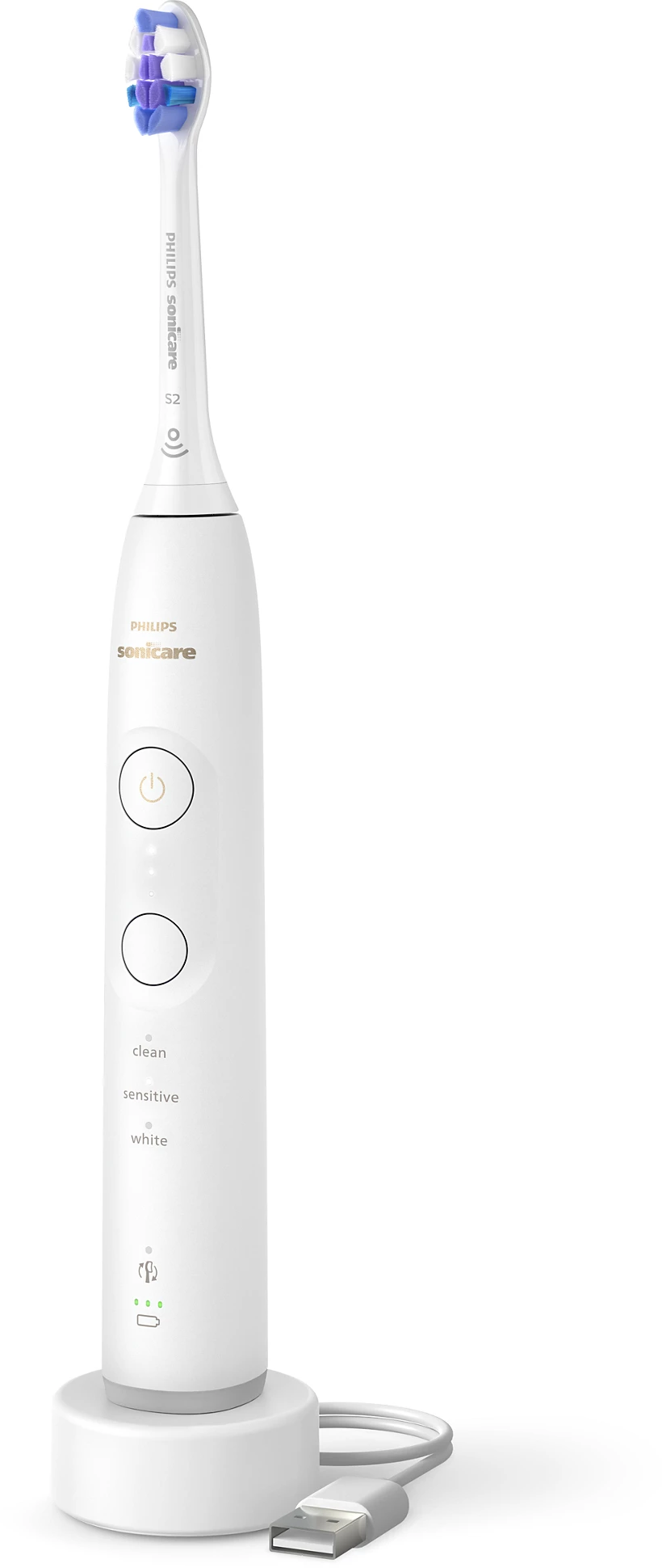 Fehér Philips Sonicare fogkefe egy töltőállomáson USB kábellel.