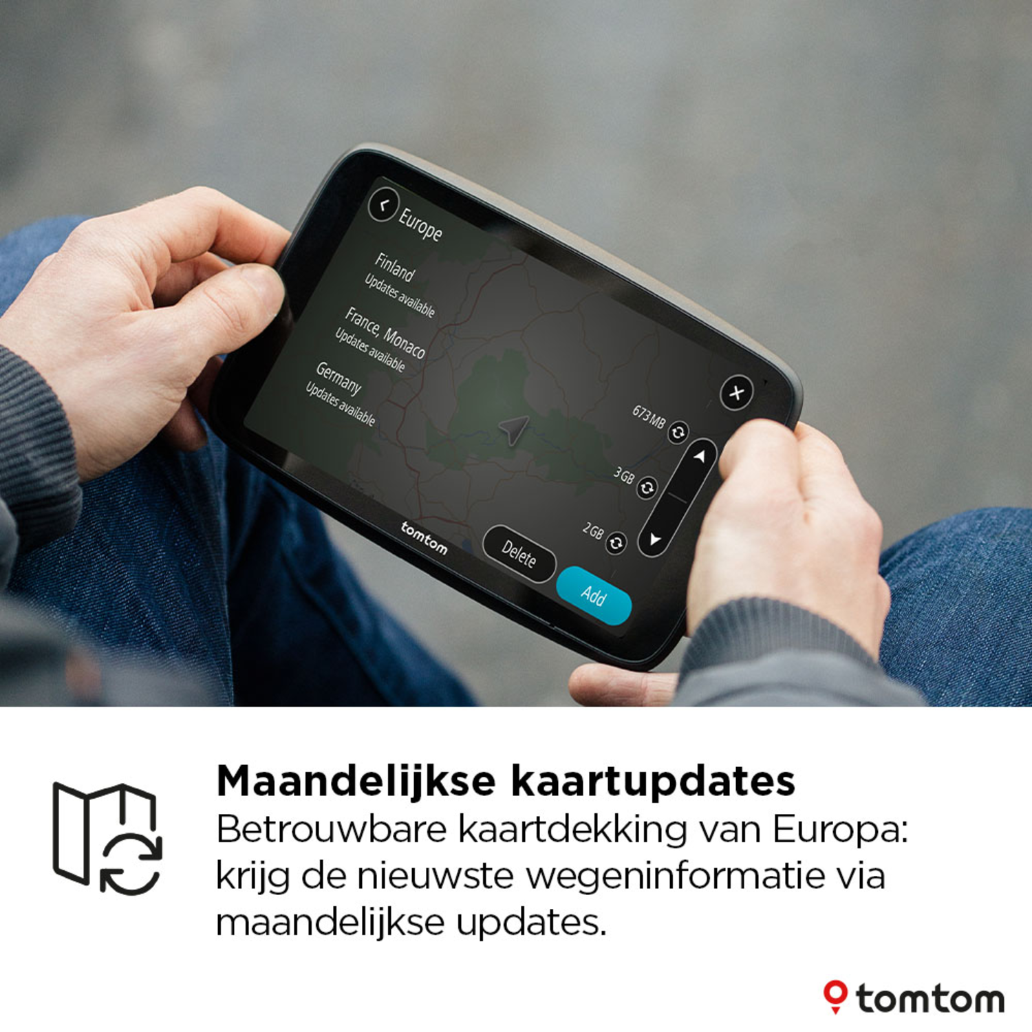 A person holding a TomTom navigation device showing a map with European updates.