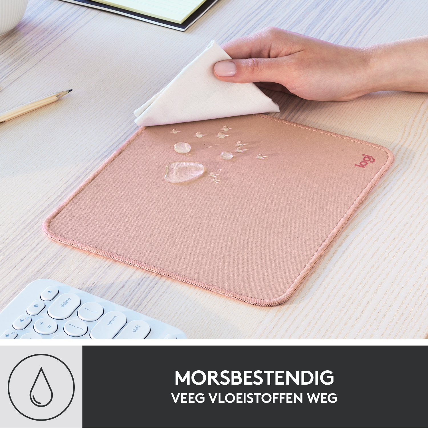 A pink mousepad with a white cloth wiping water drops.