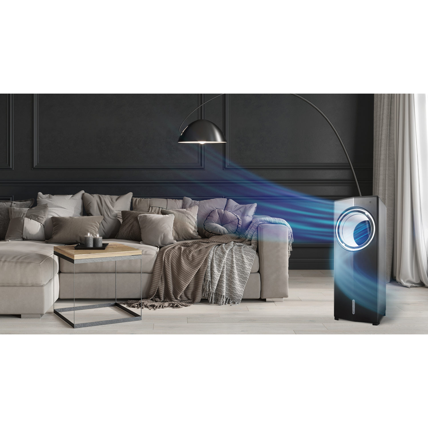Un refroidisseur d'air noir est dans un salon. Un canapé avec des oreillers, une table et une lampe sont également visibles.