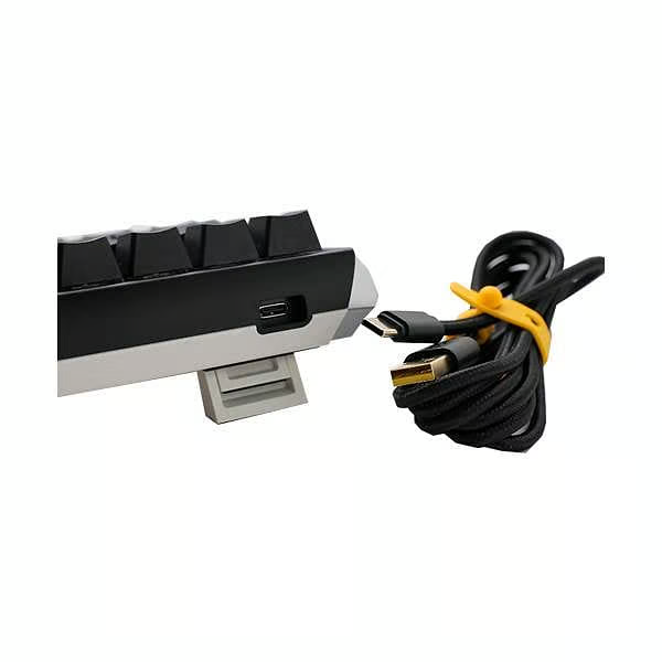 Un teclado en blanco y negro con un cable USB-C.