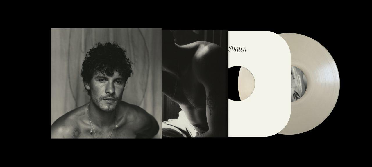 Schwarzweißfoto, ein Mann ohne Hemd mit Vinyl.