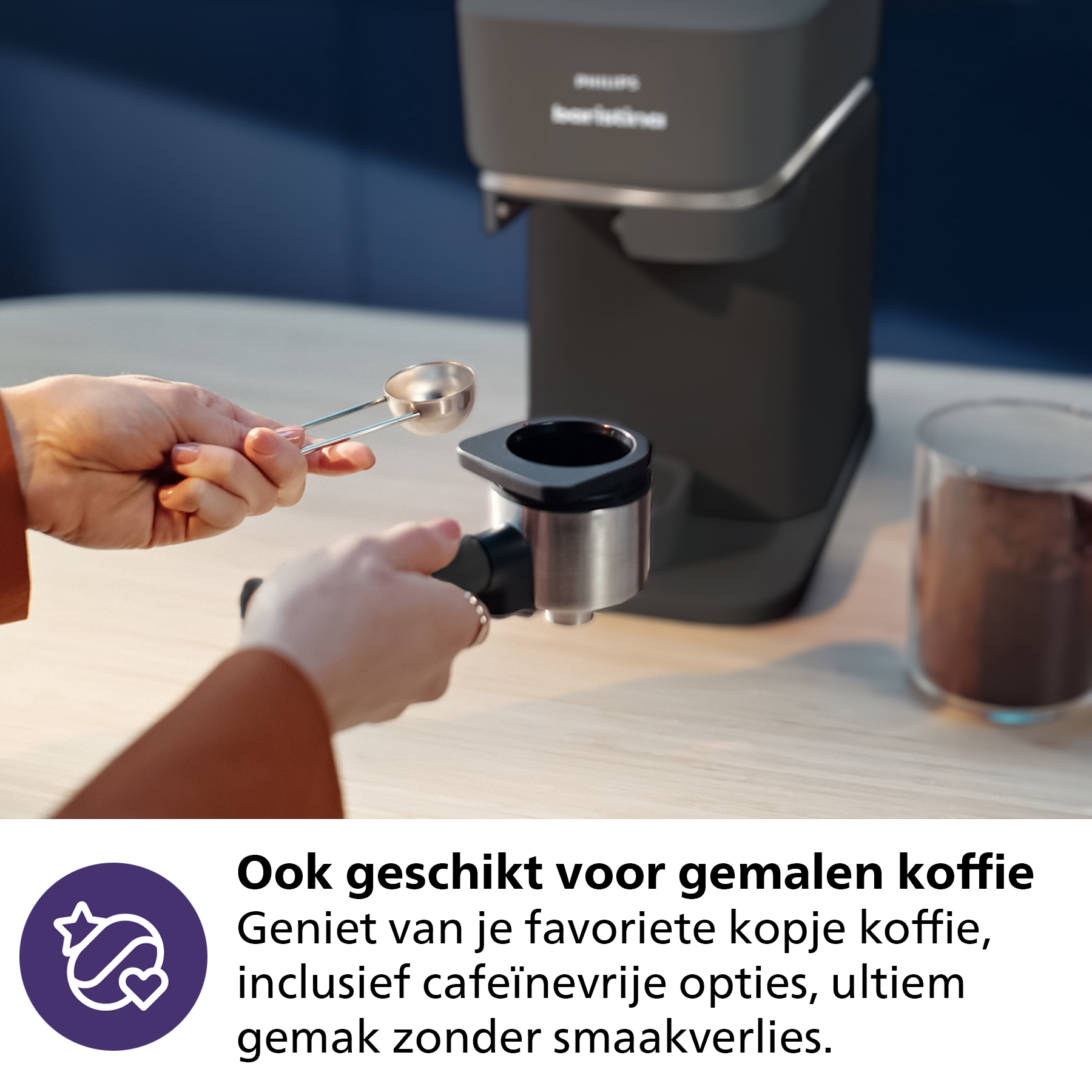 Hands filling a portafilter with coffee grounds. A coffee machine is in the background.