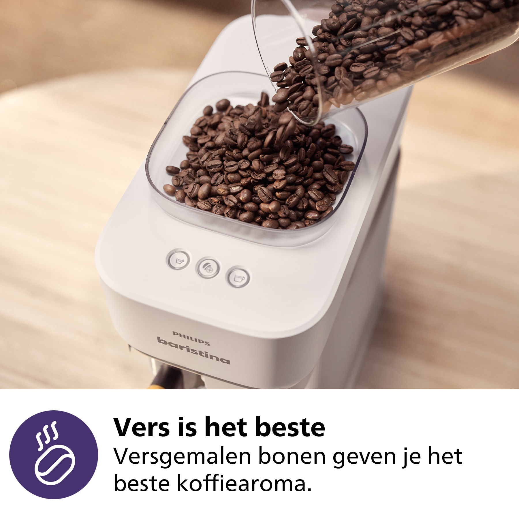 Coffee beans being poured into a white Philips Baristina coffee machine.