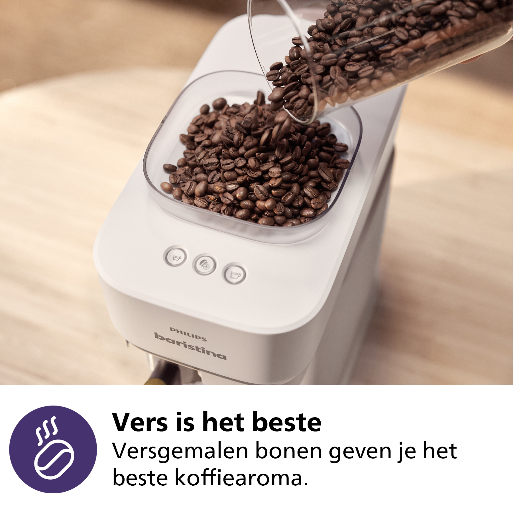 Coffee beans being poured into a white Philips Baristina coffee machine.
