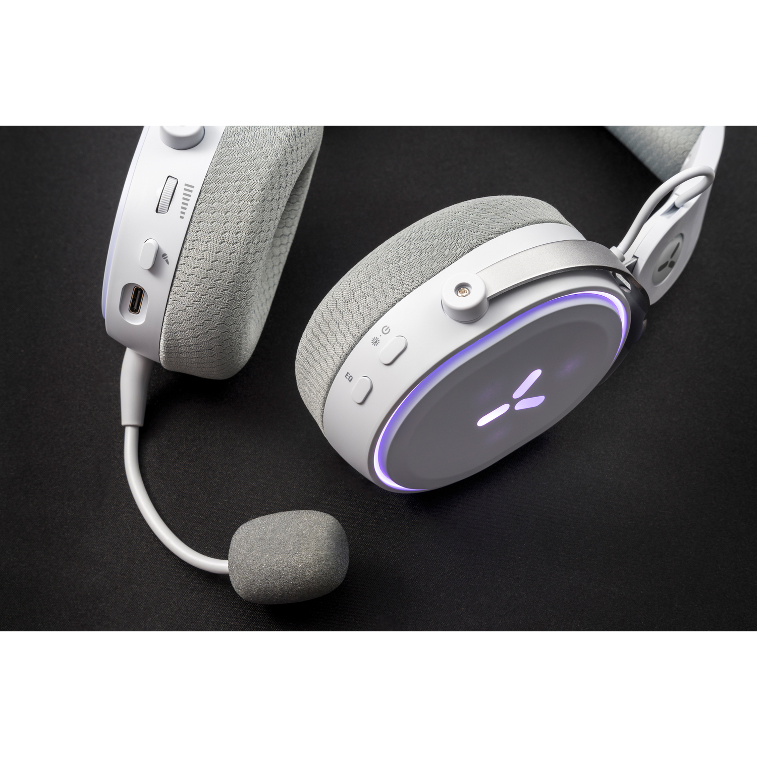 White and gray gaming headset with a microphone. The headset has a light-up ring and volume controls.