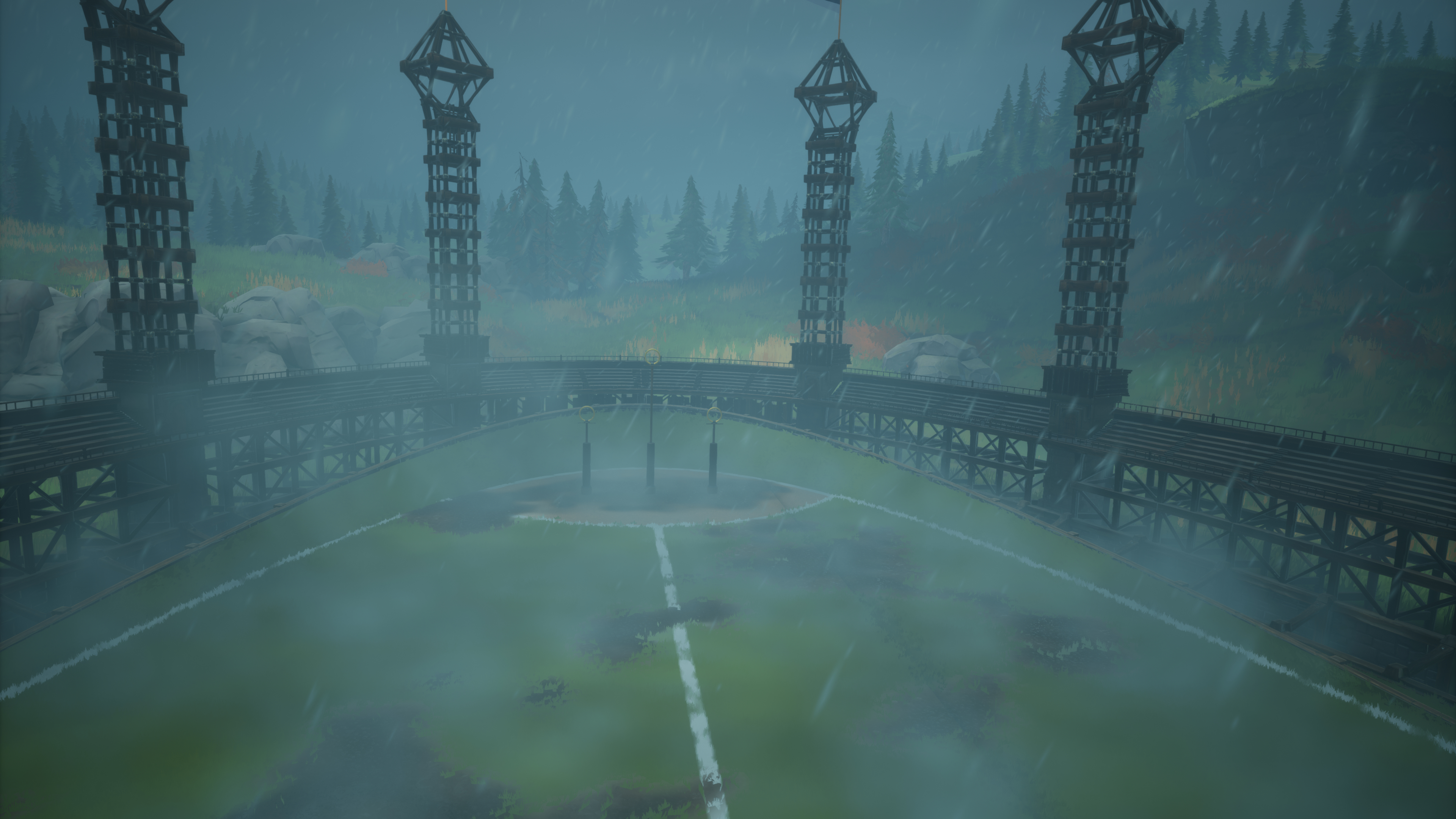 Ein Stadion mit vier Türmen, einem grünen Feld und einem nebligen Tag.