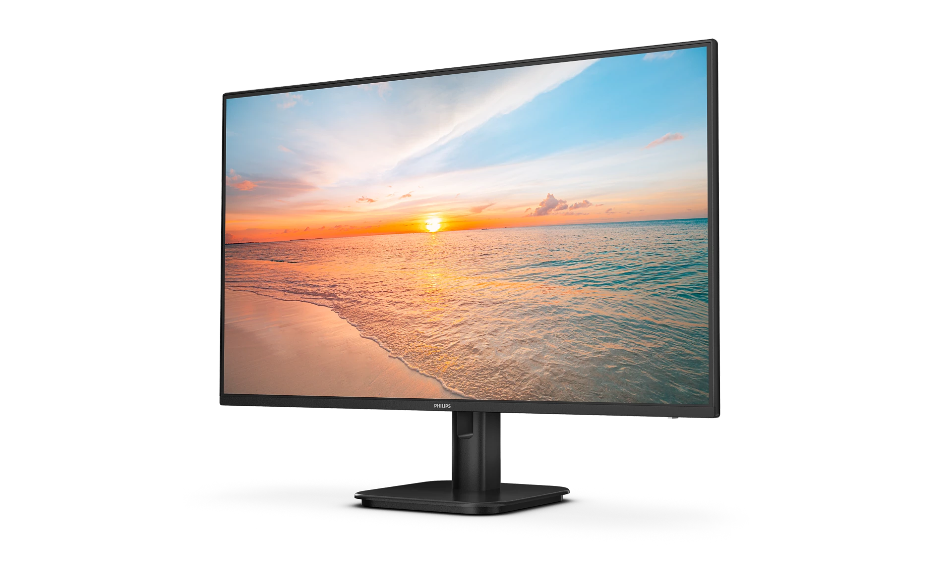 Un monitor de computadora muestra una escena de playa al atardecer con océano azul y cielo naranja.