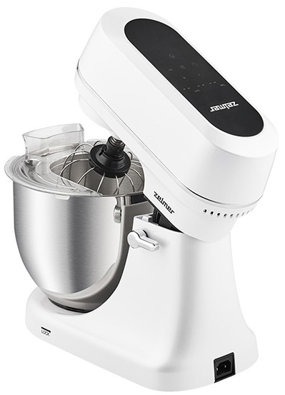Biały mikser stojący z misą i trzepaczką, uniesiony do góry.