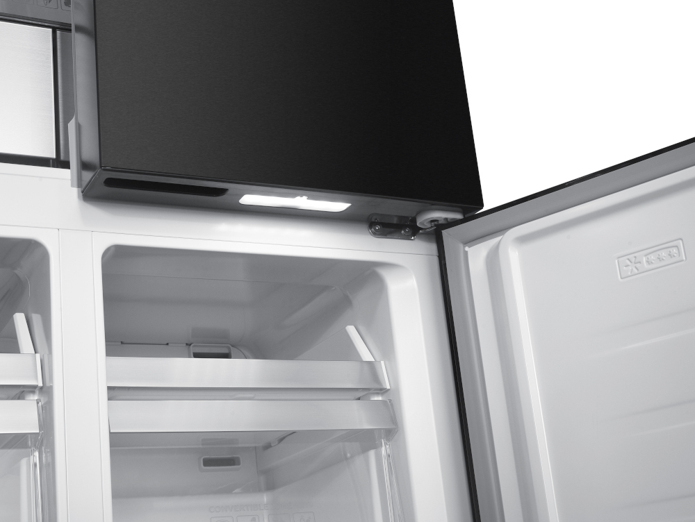 Inside of a white refrigerator with open doors. Black panel on the top.