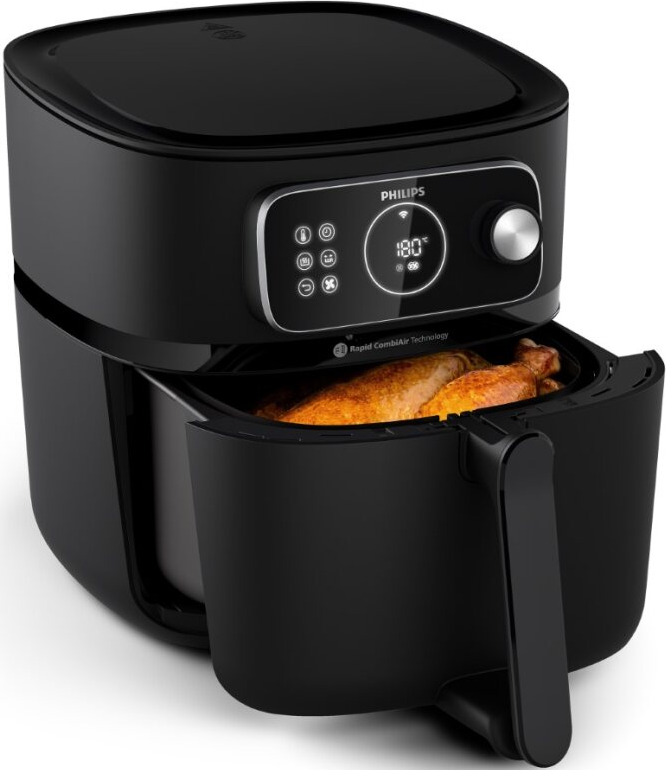 Friteuse à air noire avec le tiroir ouvert. Un poulet cuit est à l'intérieur, avec un affichage numérique.