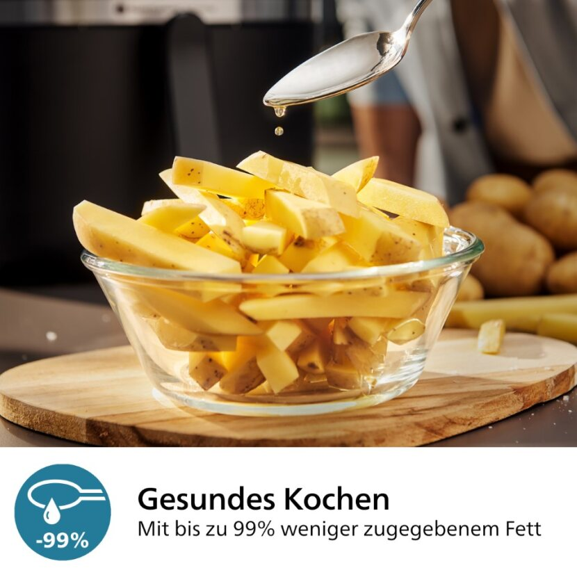 Bol en verre avec pommes de terre coupées et une cuillère versant de l'huile. Concept de cuisine saine.