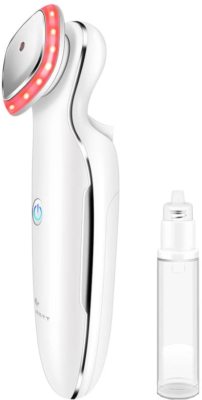 Białe urządzenie kosmetyczne. Czerwone światło na górze. Butelka z płynem obok. Białe tło.