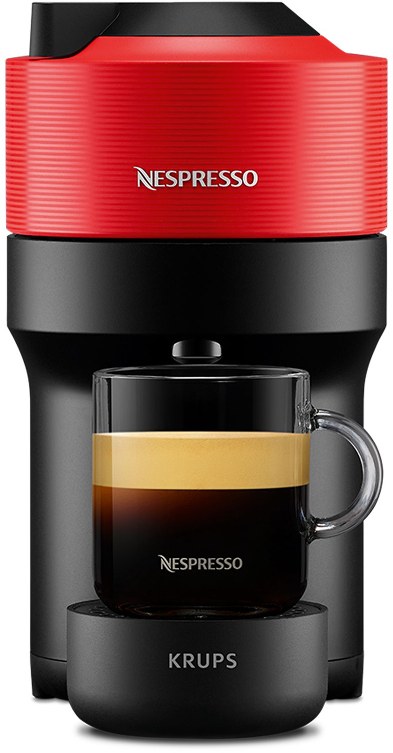 Una macchina da caffè Nespresso rossa e nera con un bicchiere pieno di caffè.