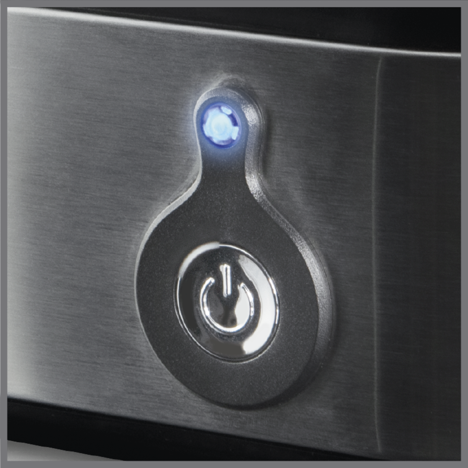 Close-up of a power button with a blue light.