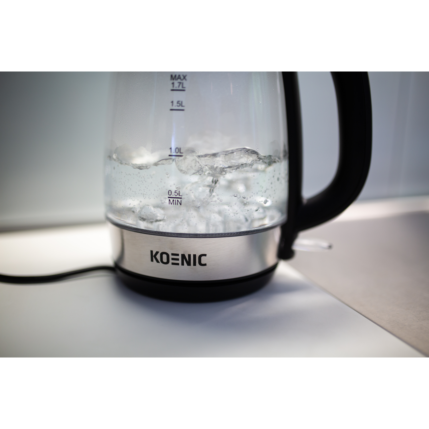 Clear glass electric kettle with water. The KOENIC logo is visible.