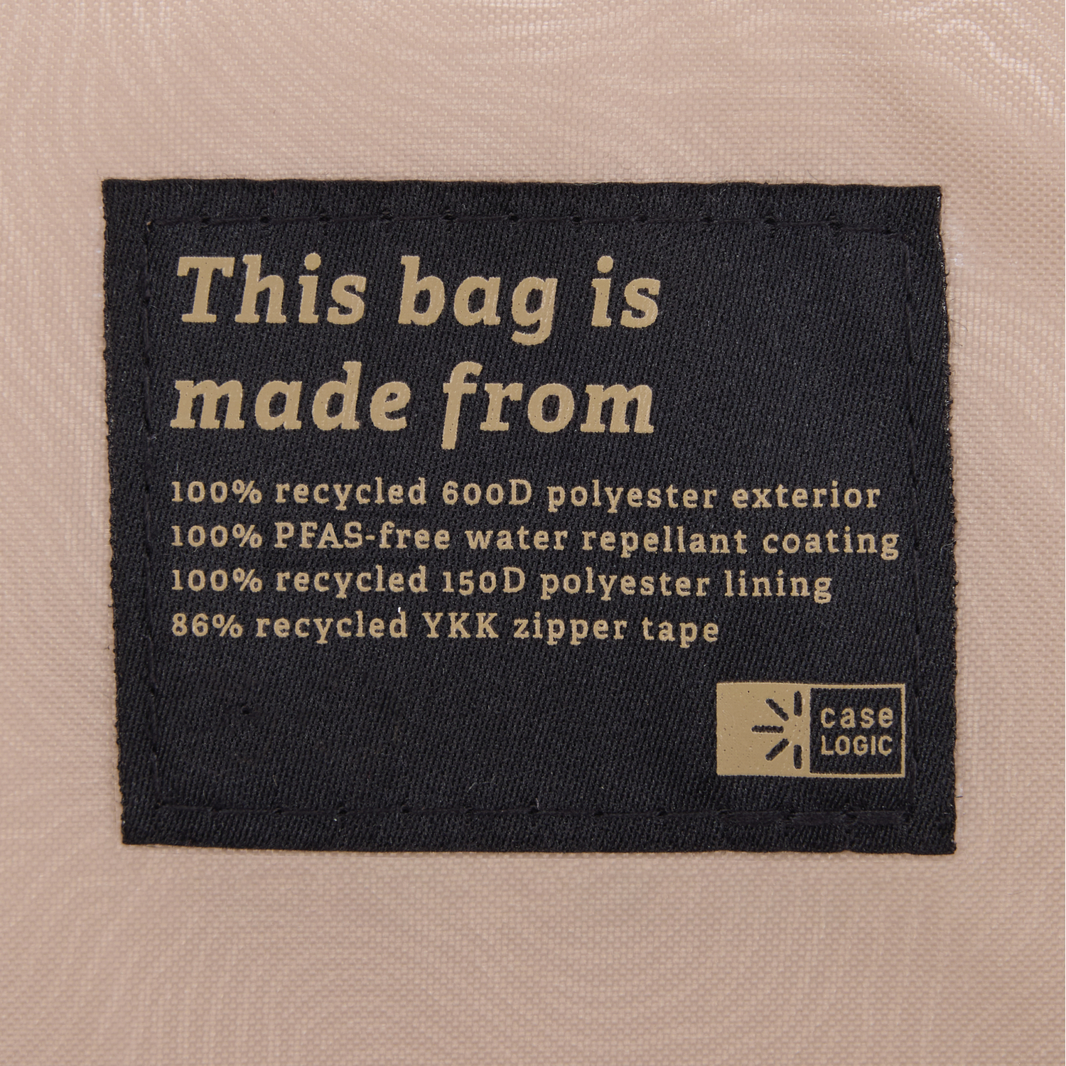 Black tag with white text. It describes the bag is made from recycled materials.