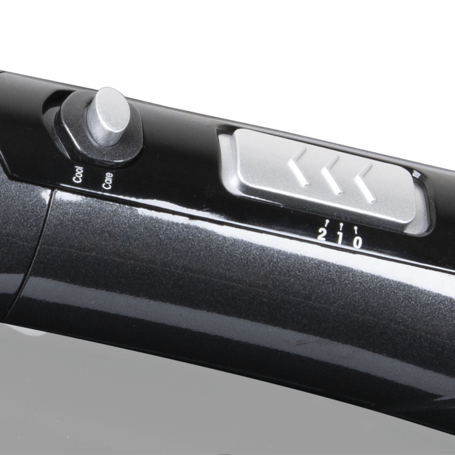 Close-up of a black hair dryer's control panel with a silver dial and switch.