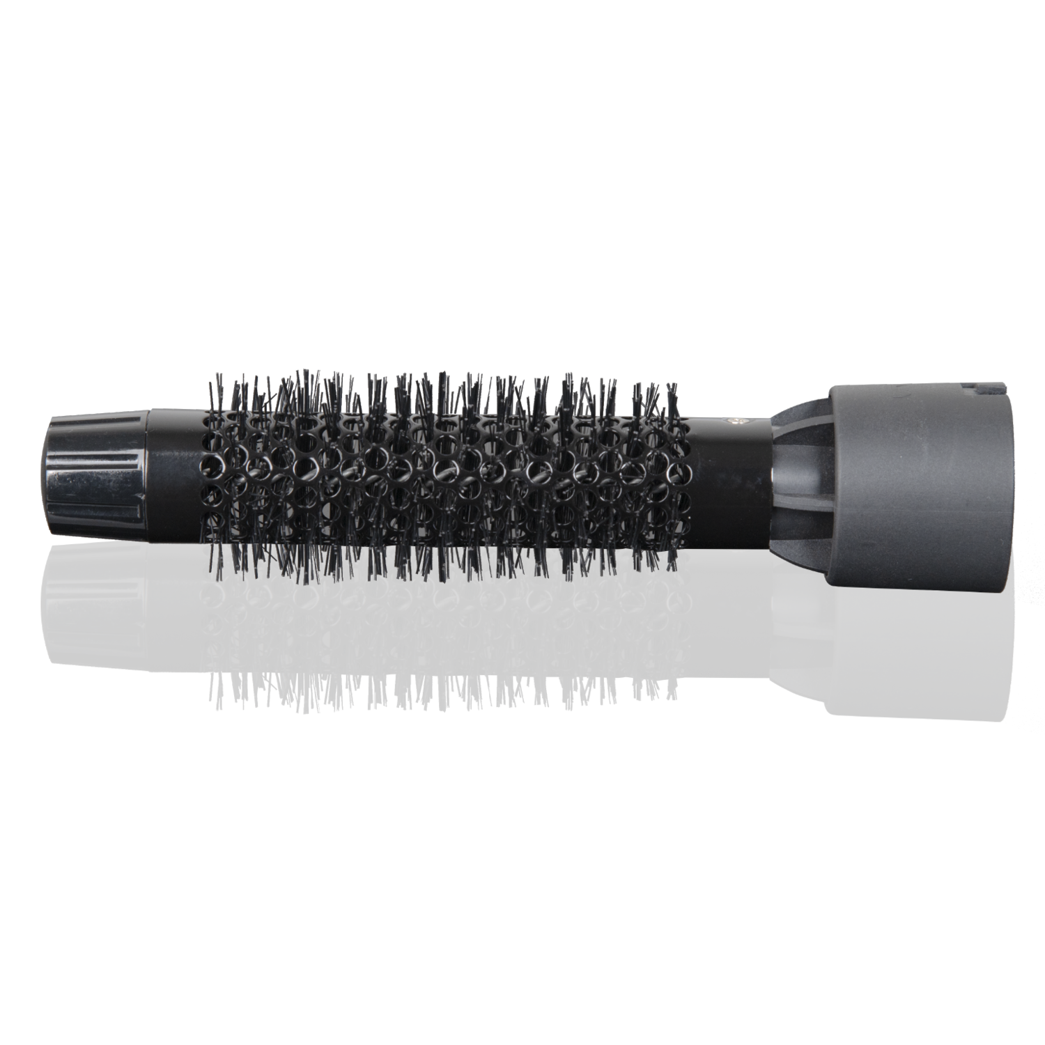 A black hair styling brush with many bristles, reflected on a black surface.