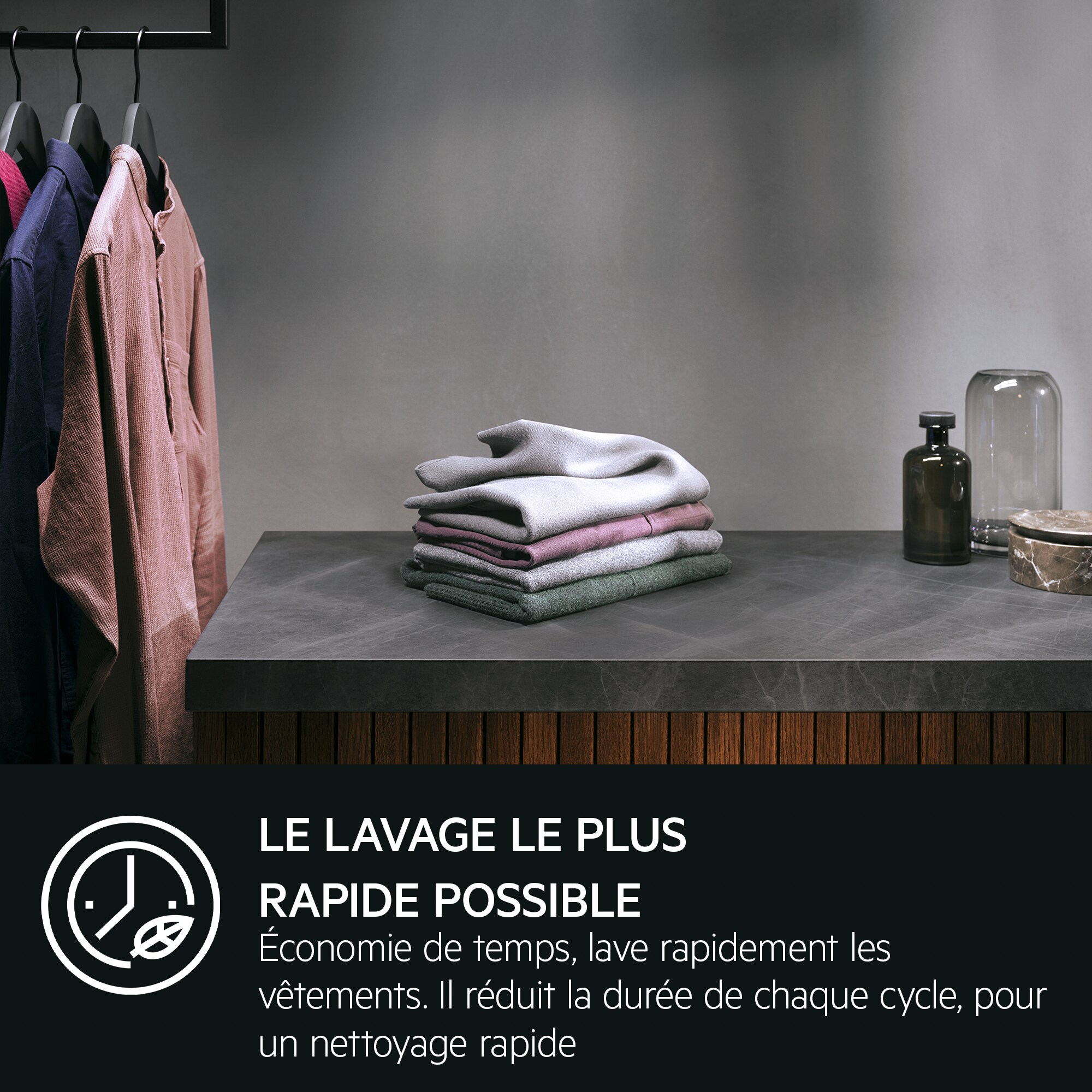 Folded clothes on a counter with a bottle and text that says 'FASTEST WASH POSSIBLE'.