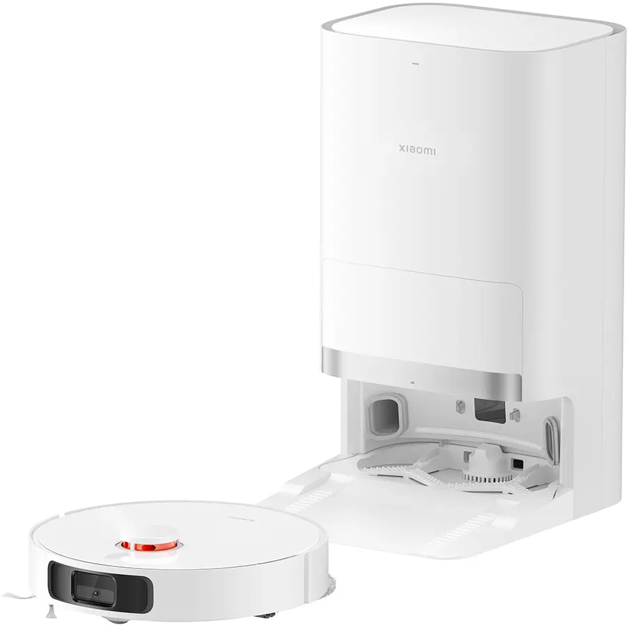 Aspirateur robot blanc avec station de charge. L'aspirateur est à côté.
