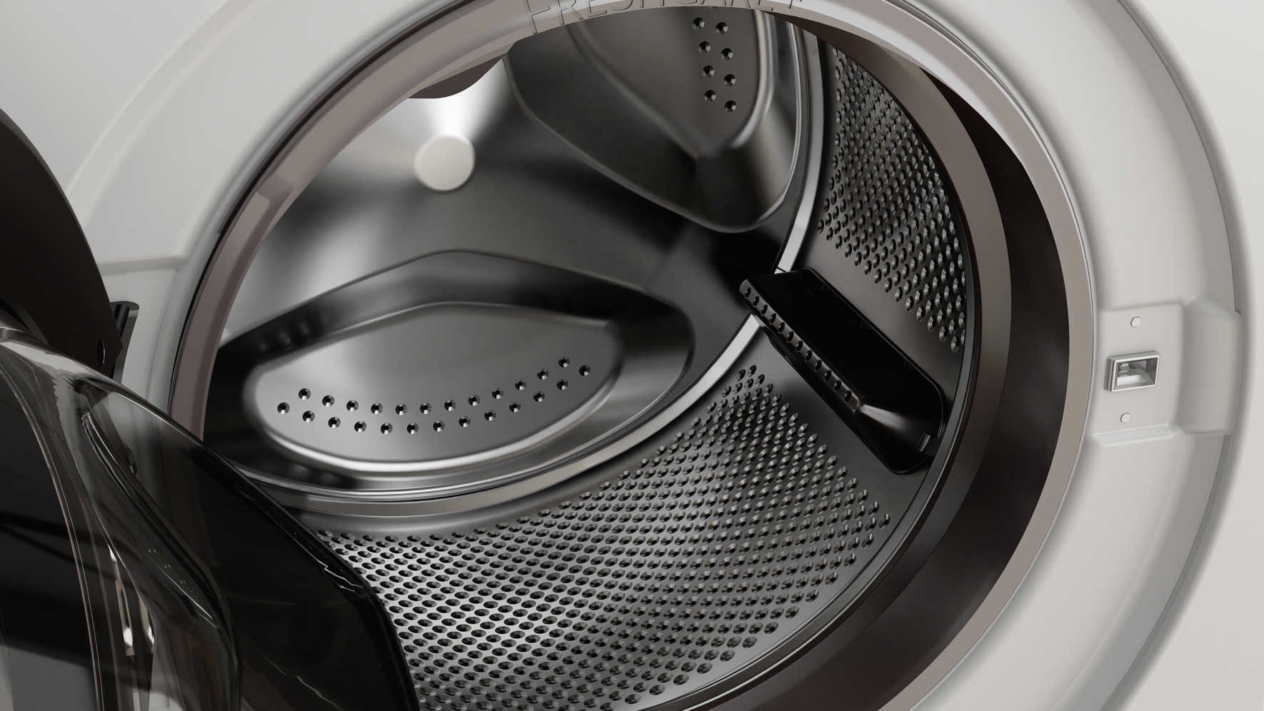 Gros plan sur le tambour d'une machine à laver avec la porte partiellement ouverte.
