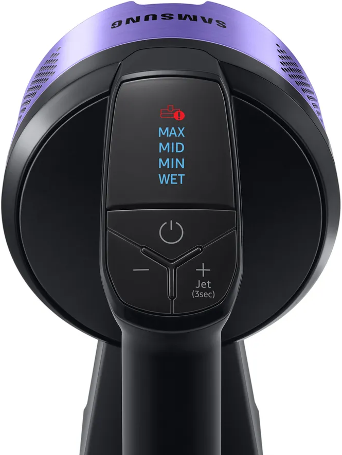 Gros plan sur une poignée d'aspirateur noire avec boutons d'alimentation et de mode, avec un dessus violet.