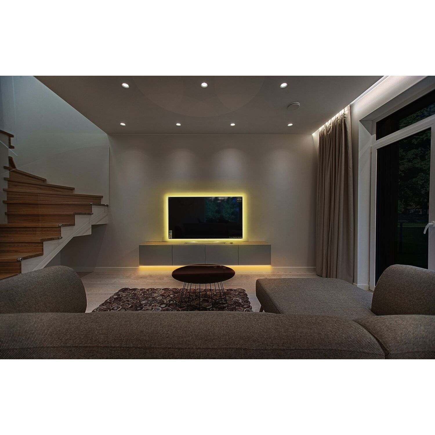 A modern living room with a TV, a gray cabinet, and a brown sofa.