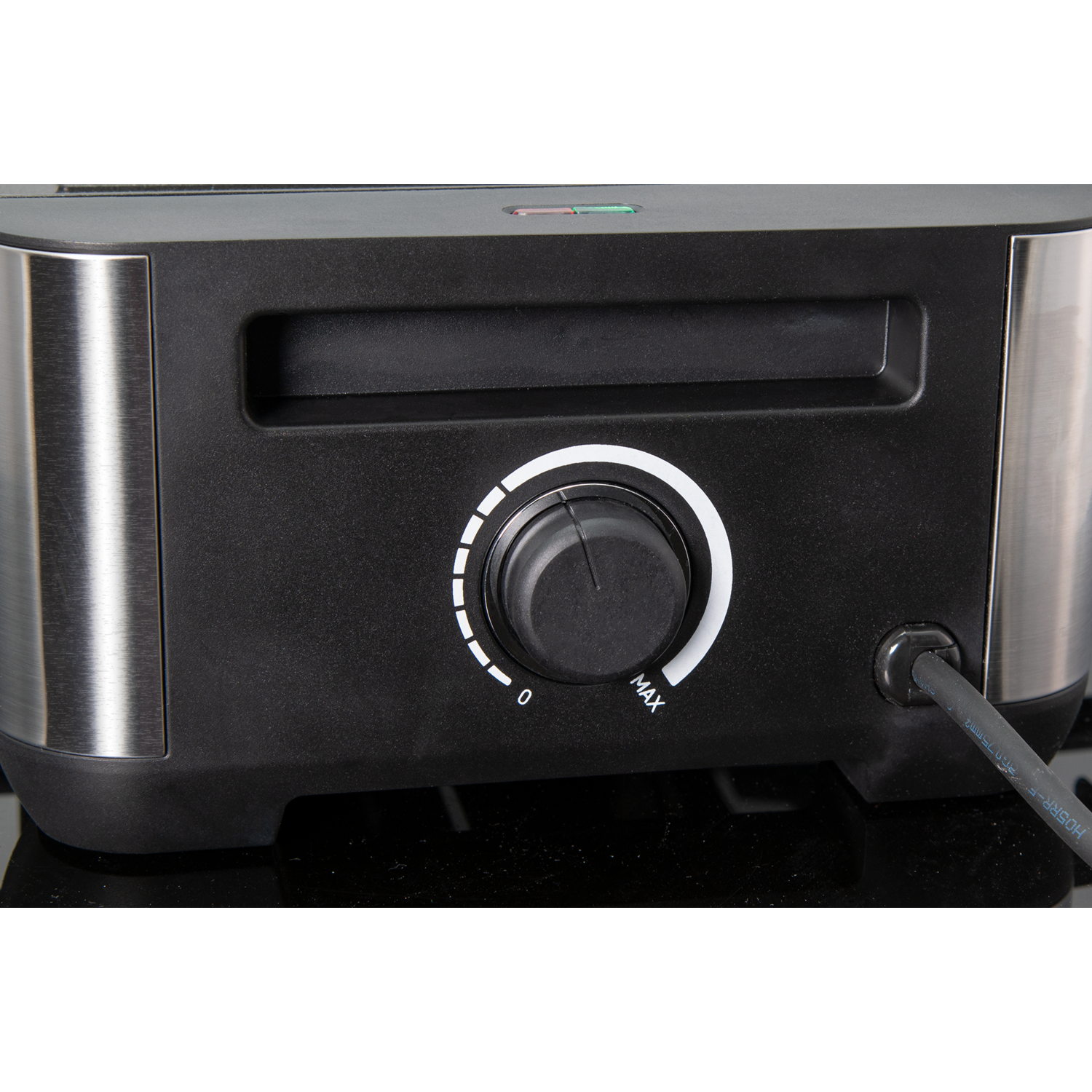 Close-up of a toaster oven control panel. It has a dial and a button.