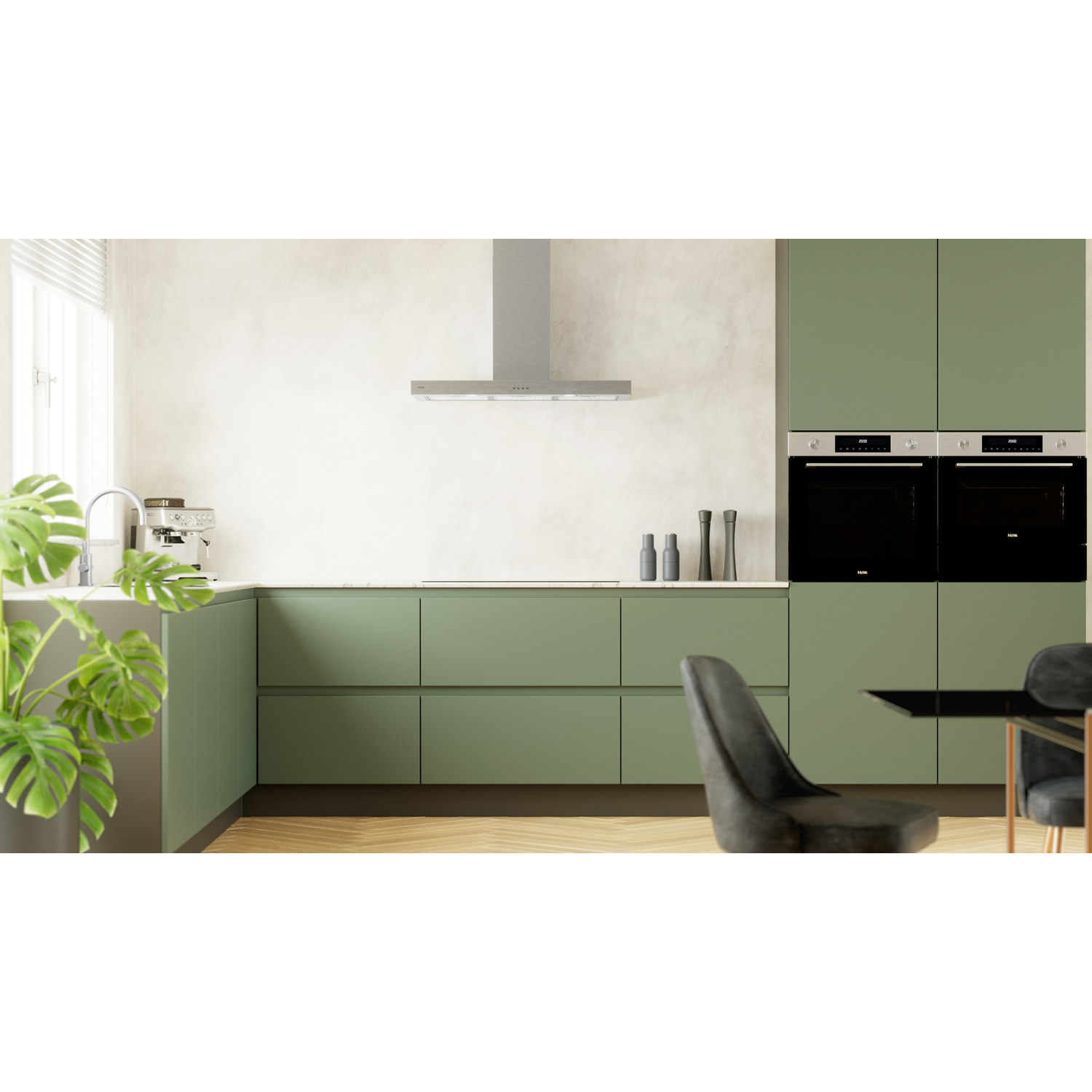 Modern green kitchen with appliances, a plant, and a dining area.