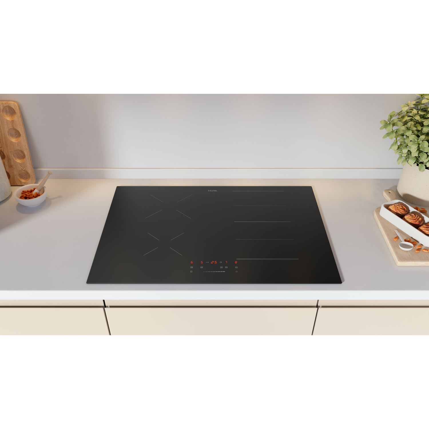 A black built-in cooktop on a light-colored countertop. It has four burners and touch controls.