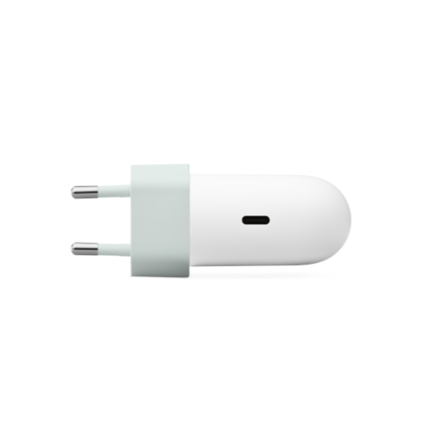Een witte en lichtgroene oplader met twee zilveren pennen en een zwarte stip.