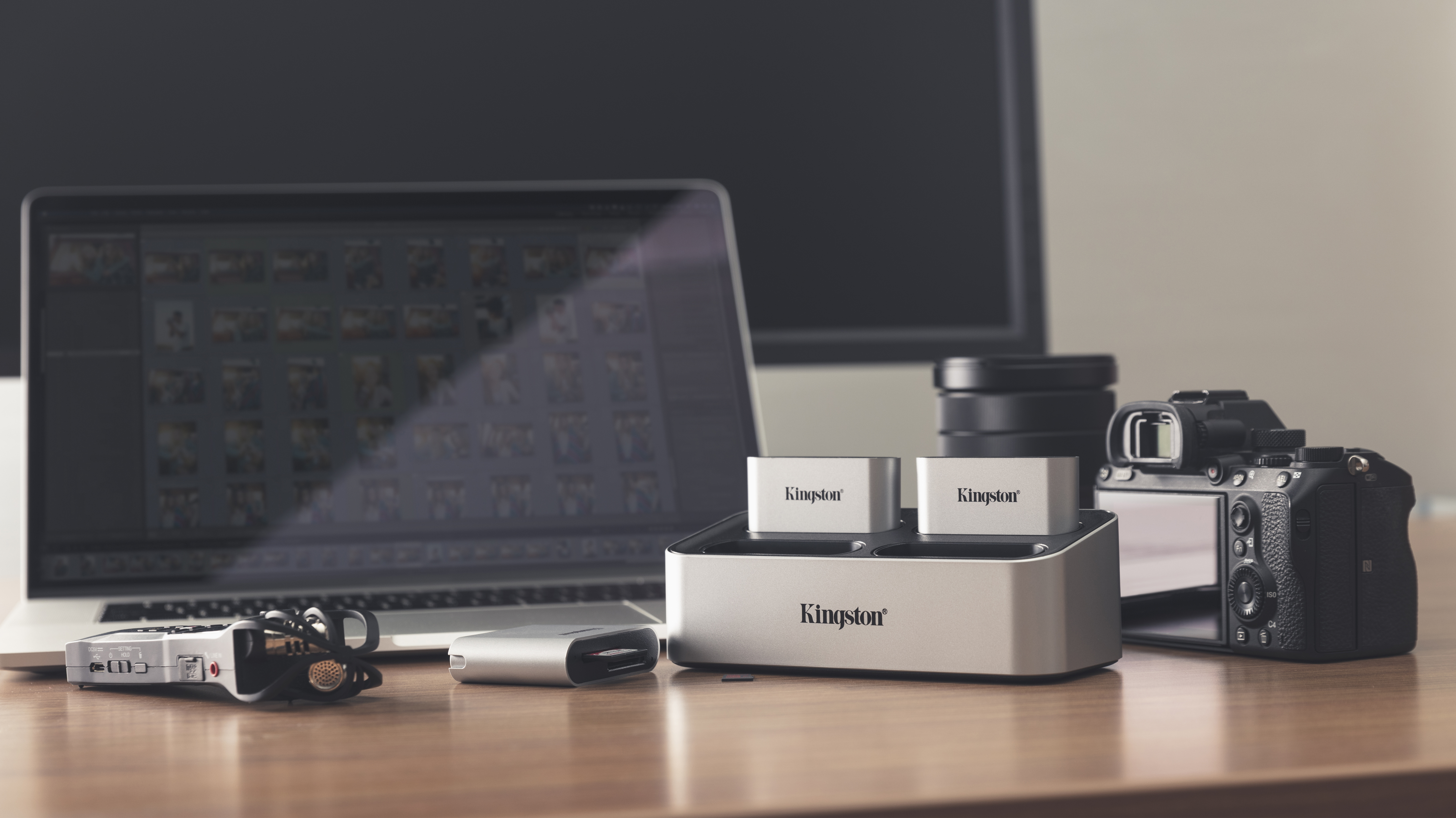 Schreibtisch mit Laptop, Ladegerät, Kamera und Kingston Kartenleser. Foto-Setup.