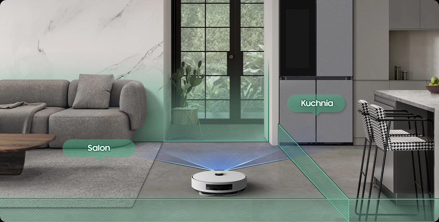 Robot sprzątający w salonie, kuchnia widoczna w tle.