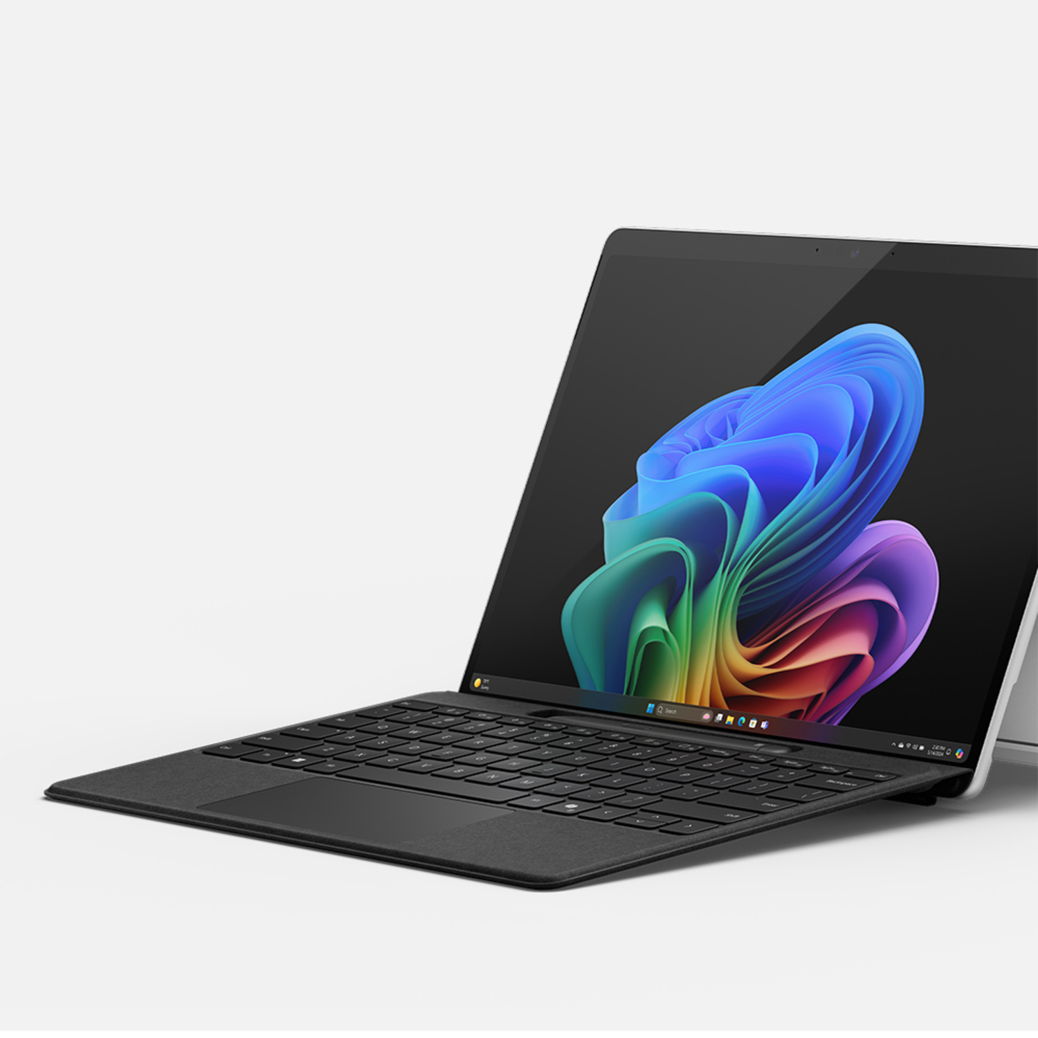 A laptop with a black keyboard and a colorful abstract wallpaper.