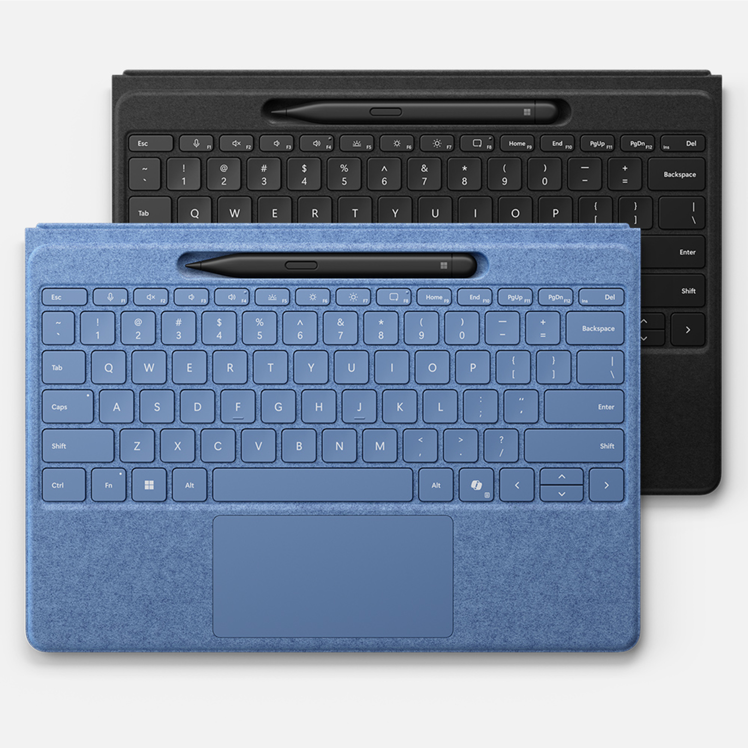 Two keyboard covers side by side, one black and one blue with a black pen.