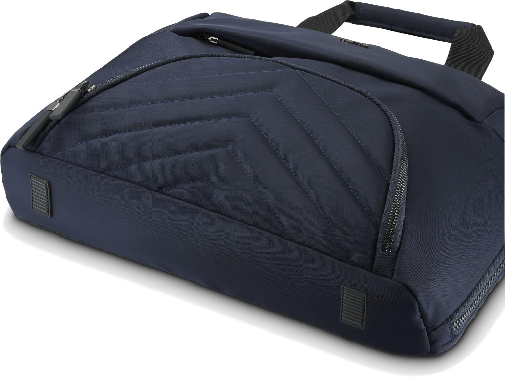 Granatowa torba na laptopa. Torba jest zamykana na zamek błyskawiczny. Tło jest białe.