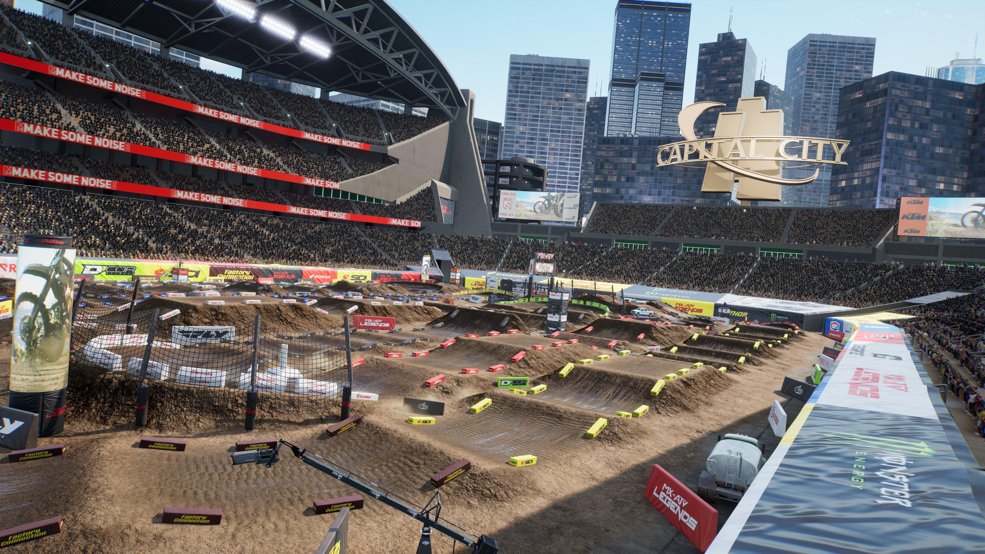 Stadionansicht eines Motocross-Rennens. Fahrer und Hindernisse sind vorhanden.