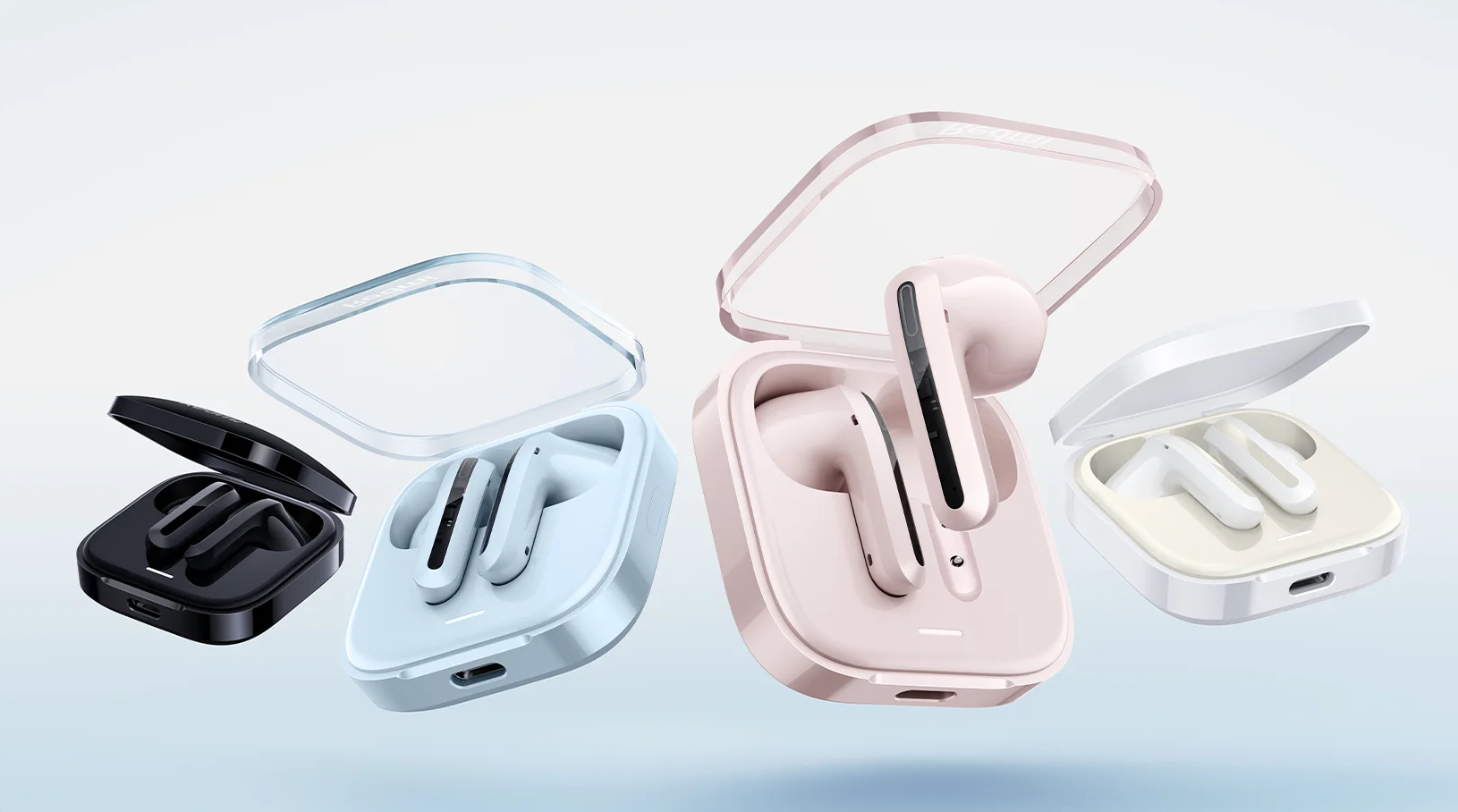 Cztery zestawy bezprzewodowych słuchawek w etui ładujących w różnych kolorach.