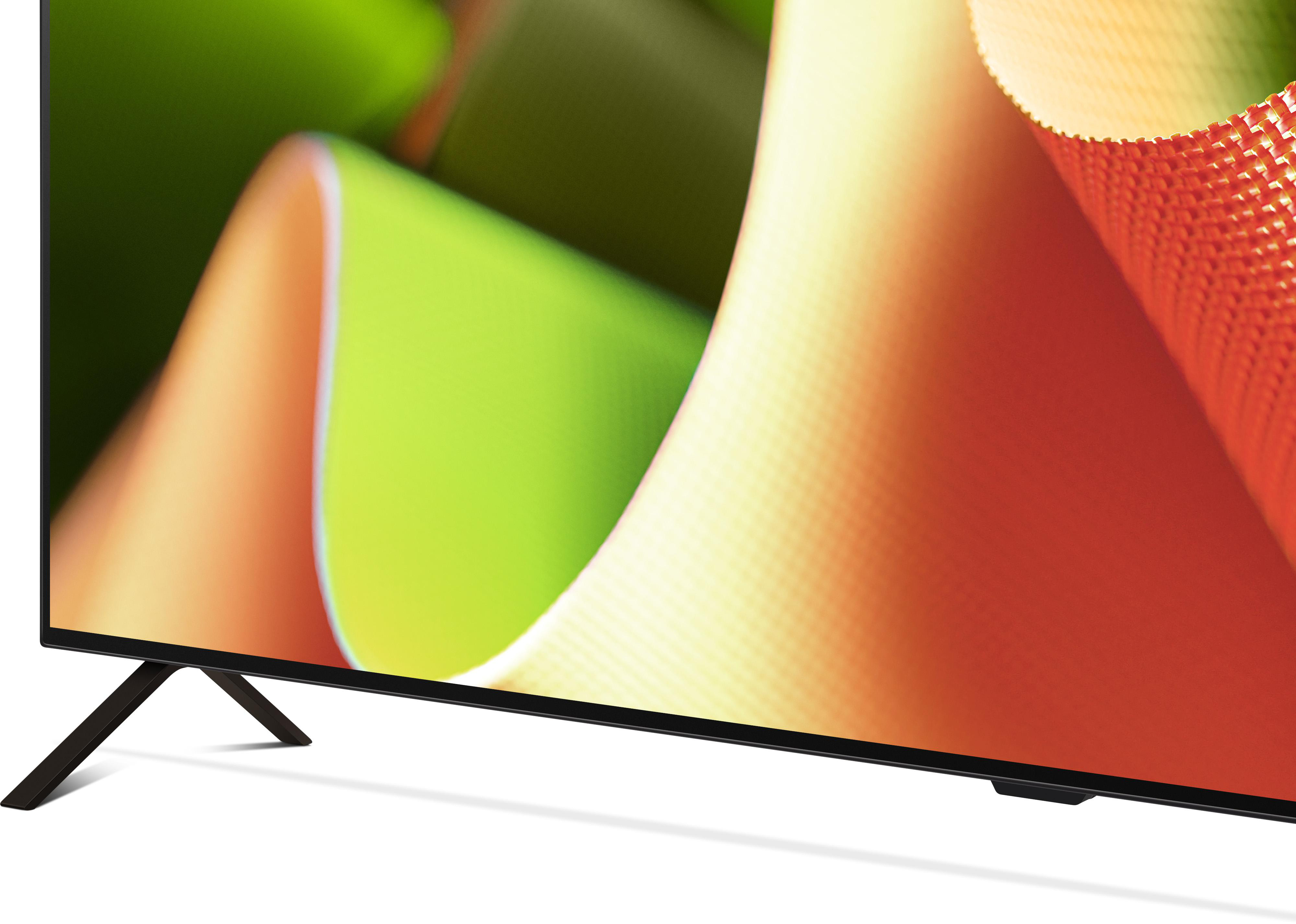 Nahaufnahme eines modernen Fernsehers mit schwarzem Bildschirm und schlankem, dunklem Ständer.