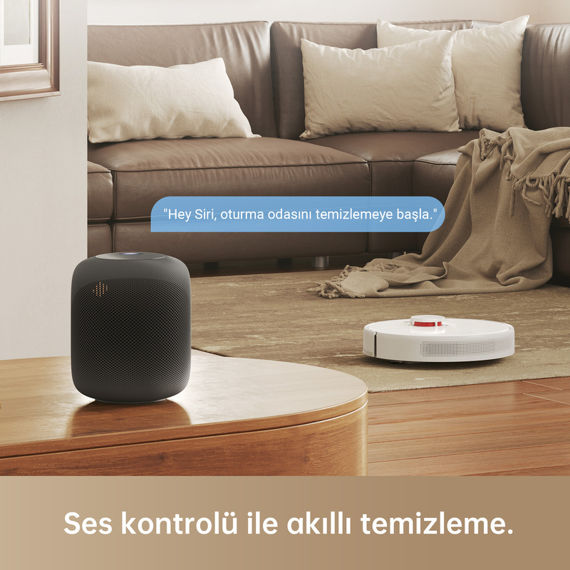 Bir masada robot süpürge ve akıllı hoparlör. Bir konuşma balonu, 'Hey Siri, temizlemeye başla' diyor.